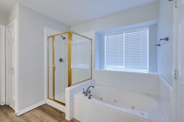 bathroom with hardwood / wood-style flooring and independent shower and bath