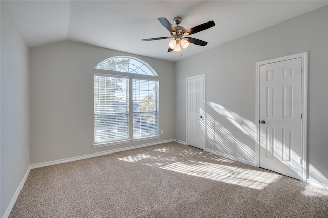 unfurnished room featuring vaulted ceiling, ceiling fan, and carpet floors