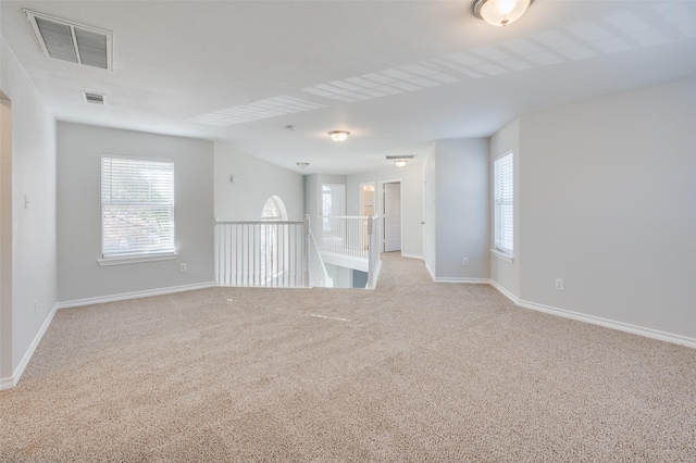 unfurnished room with light colored carpet