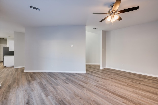 unfurnished room featuring ceiling fan and light hardwood / wood-style flooring