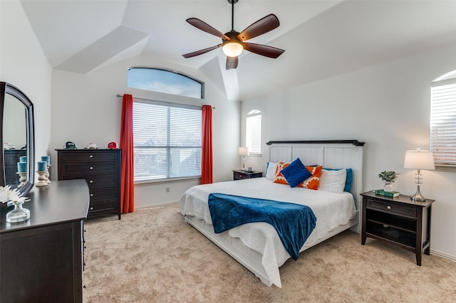 carpeted bedroom with ceiling fan and vaulted ceiling