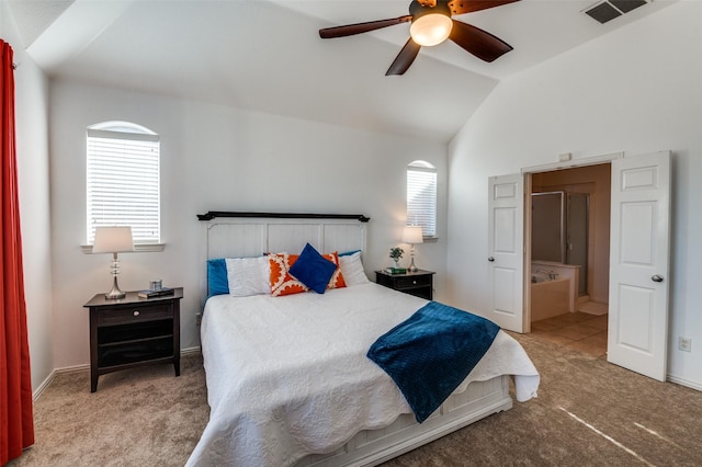 bedroom with ceiling fan, lofted ceiling, connected bathroom, and multiple windows