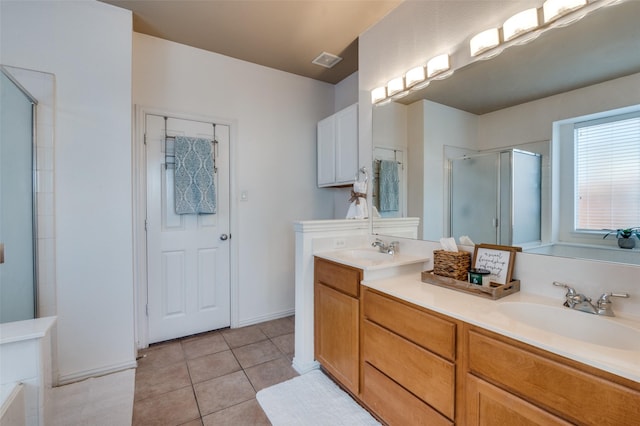 bathroom featuring an enclosed shower, vanity, and tile patterned floors