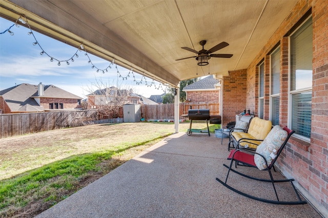 view of patio with ceiling fan and a storage shed