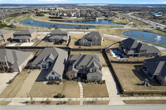 birds eye view of property with a residential view and a water view