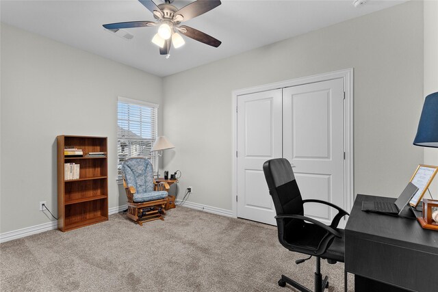 carpeted home office featuring ceiling fan, visible vents, and baseboards