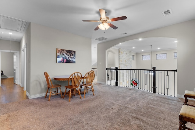 carpeted dining room featuring visible vents, attic access, and baseboards