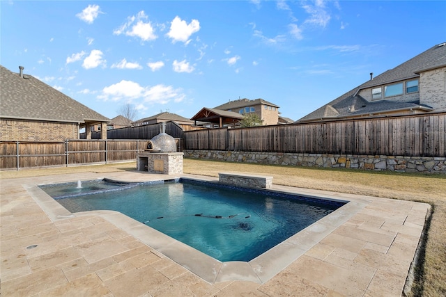 view of swimming pool with a fenced backyard, a fireplace, and a patio