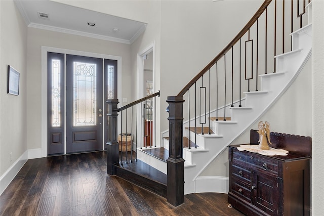 foyer entrance with ornamental molding, hardwood / wood-style floors, and baseboards