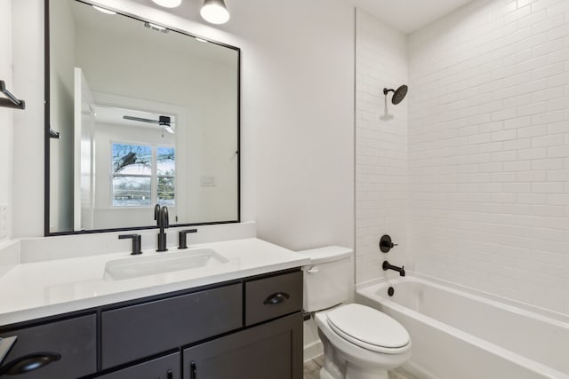 full bathroom with toilet, vanity, and tiled shower / bath