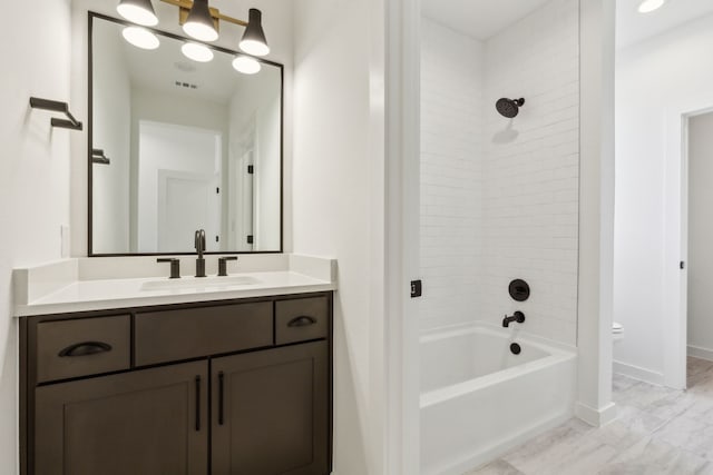 full bathroom with tiled shower / bath combo, vanity, and toilet