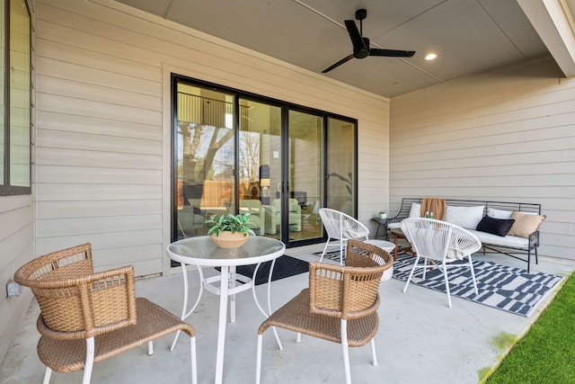 view of patio / terrace with ceiling fan and an outdoor living space