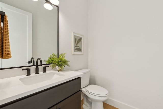 bathroom with toilet and vanity