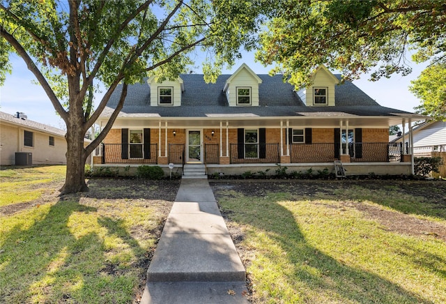 view of front of home featuring covered porch, a front yard, and central air condition unit