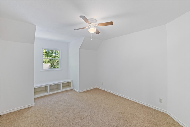 additional living space featuring ceiling fan, light carpet, and vaulted ceiling