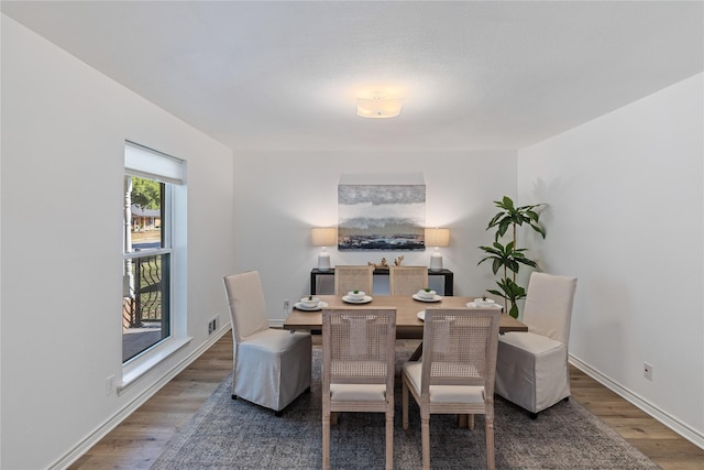 dining space with dark hardwood / wood-style floors