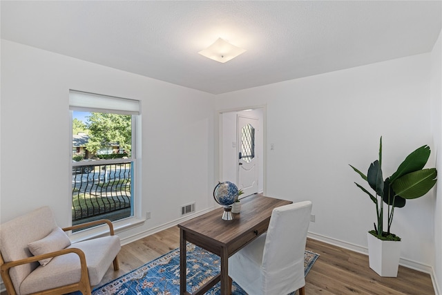 office space with hardwood / wood-style floors