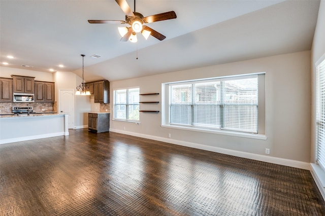 unfurnished living room featuring lofted ceiling, ceiling fan with notable chandelier, and dark hardwood / wood-style flooring