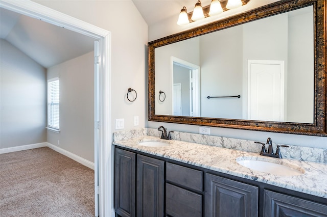 bathroom featuring lofted ceiling and vanity