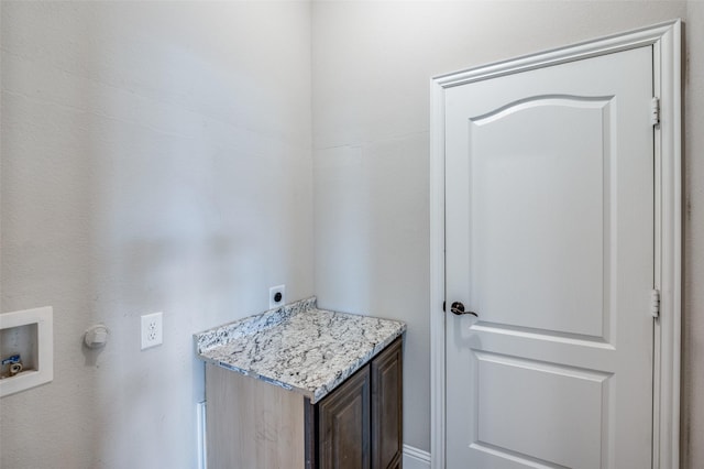 clothes washing area featuring cabinets, washer hookup, and hookup for an electric dryer