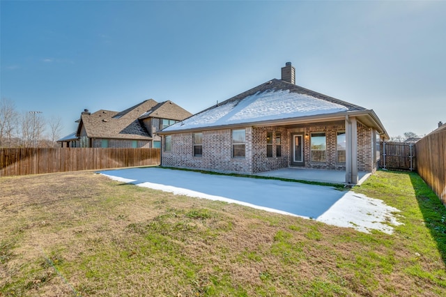 back of house featuring a patio area and a lawn