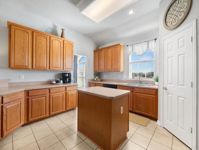 kitchen with light tile patterned floors, plenty of natural light, sink, and a center island