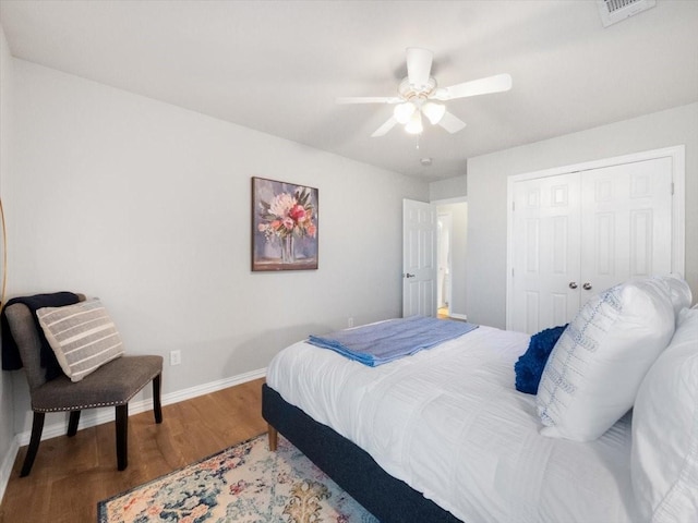 bedroom with ceiling fan, hardwood / wood-style floors, and a closet