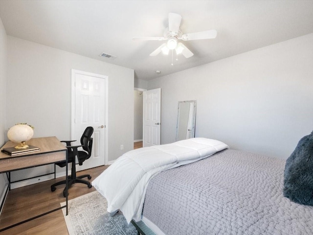 bedroom with ceiling fan and hardwood / wood-style floors