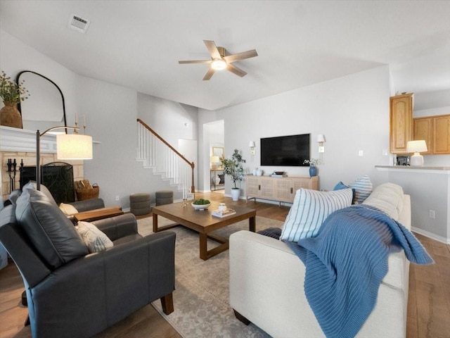 living room featuring ceiling fan and light hardwood / wood-style flooring