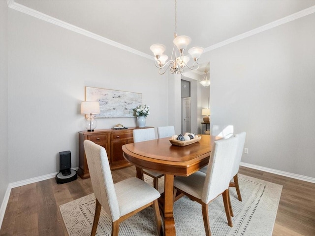 dining area featuring a chandelier, crown molding, and wood-type flooring