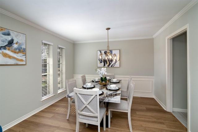 dining room with a healthy amount of sunlight, hardwood / wood-style flooring, and a notable chandelier