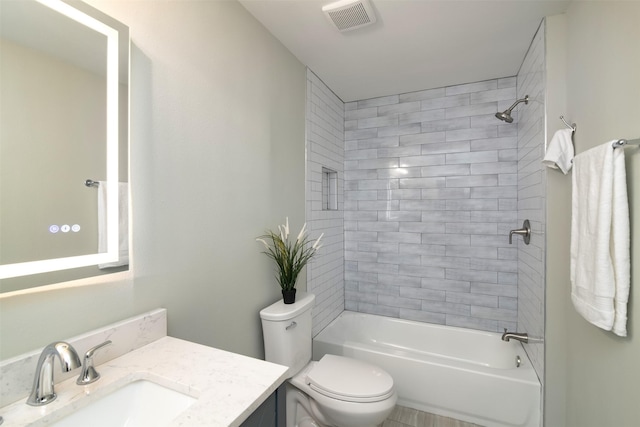 full bathroom with toilet, vanity, and tiled shower / bath combo