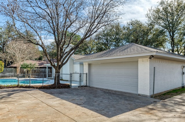 garage featuring a fenced in pool