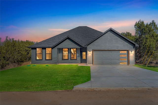 view of front of house with a yard and a garage