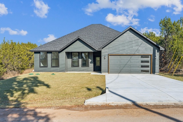 view of front of house featuring a front yard and a garage