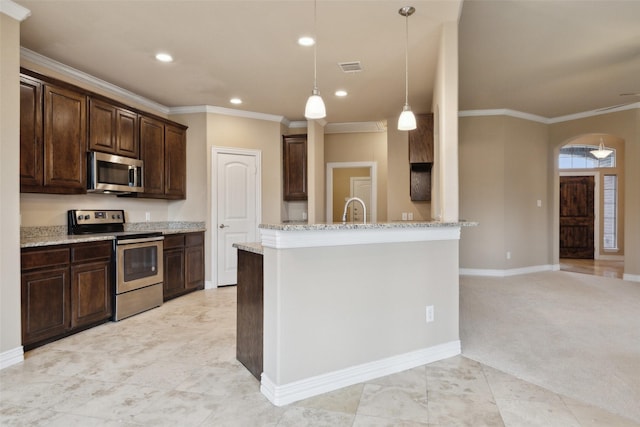 kitchen with appliances with stainless steel finishes, dark brown cabinets, hanging light fixtures, crown molding, and light stone counters