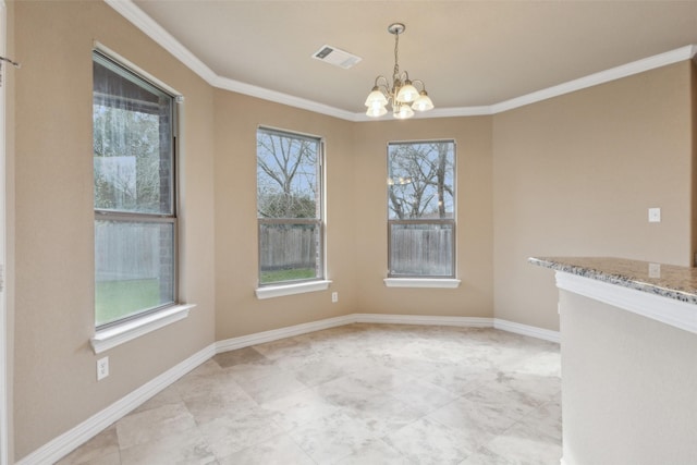 unfurnished dining area featuring a healthy amount of sunlight, crown molding, and an inviting chandelier