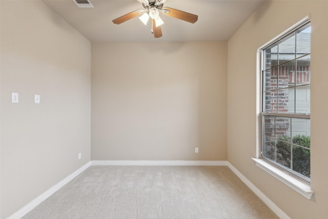 unfurnished room featuring ceiling fan and light colored carpet