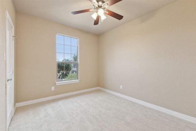 empty room featuring ceiling fan and light colored carpet