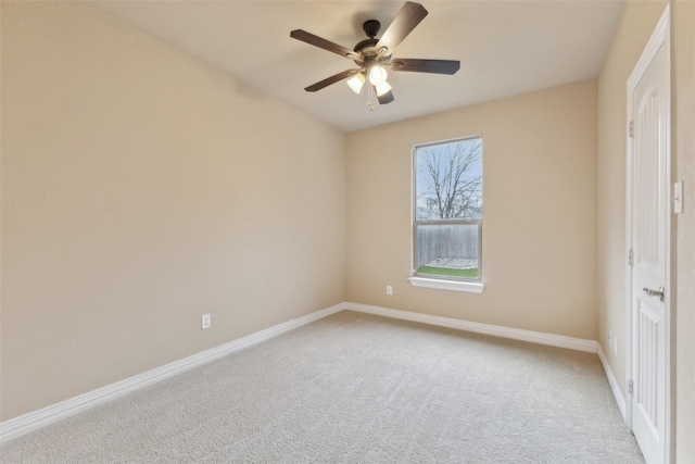 empty room with ceiling fan and light colored carpet