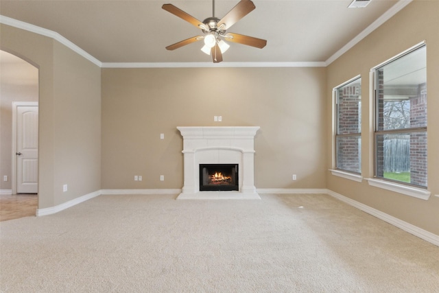 unfurnished living room with ceiling fan, light colored carpet, and ornamental molding