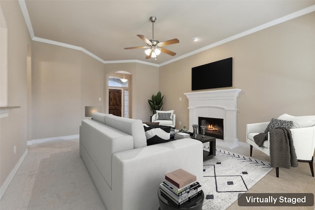 carpeted living room featuring ceiling fan and crown molding