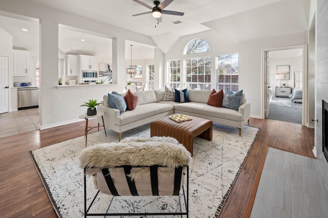 living room featuring ceiling fan and light hardwood / wood-style floors