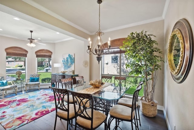 dining area with ceiling fan with notable chandelier, dark hardwood / wood-style floors, and crown molding