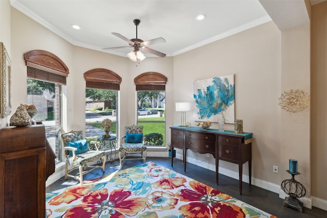 sitting room with ceiling fan, crown molding, and dark hardwood / wood-style floors