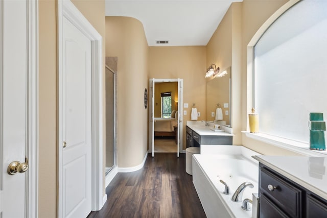 bathroom with vanity, shower with separate bathtub, and hardwood / wood-style floors