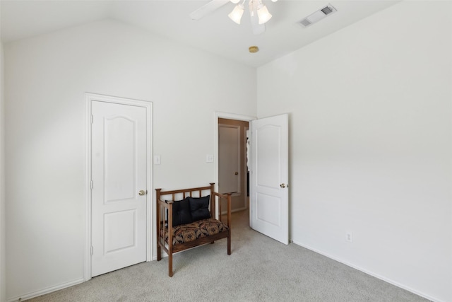 interior space featuring light carpet, ceiling fan, and lofted ceiling