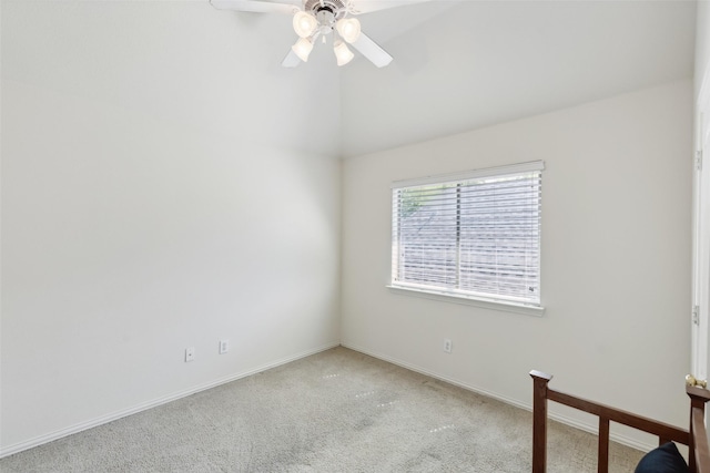 carpeted empty room featuring vaulted ceiling and ceiling fan