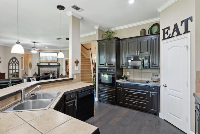 kitchen featuring black appliances, decorative light fixtures, sink, backsplash, and ceiling fan