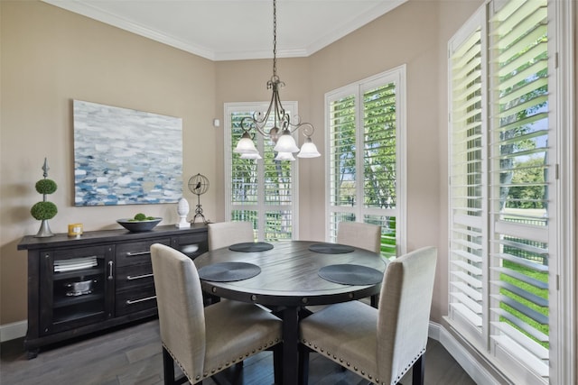 dining room with ornamental molding, dark hardwood / wood-style floors, and a chandelier